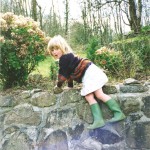 Alice rock climbing in frog boots