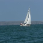 Another yacht with Skomer Island in the background.