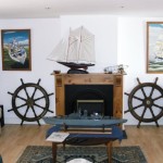 The Anchorage sitting area, nautical decor and paintings by owner